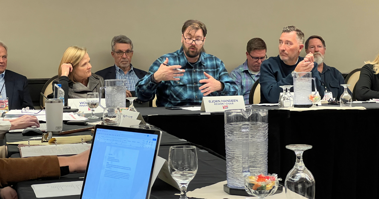Damond Watkins (right) listens to Region 1 Chair Bjorn Handeen Friday evening